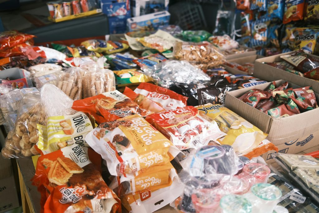 Vibrant array of assorted packaged snacks and candies displayed indoors, perfect for a snack shop or market.